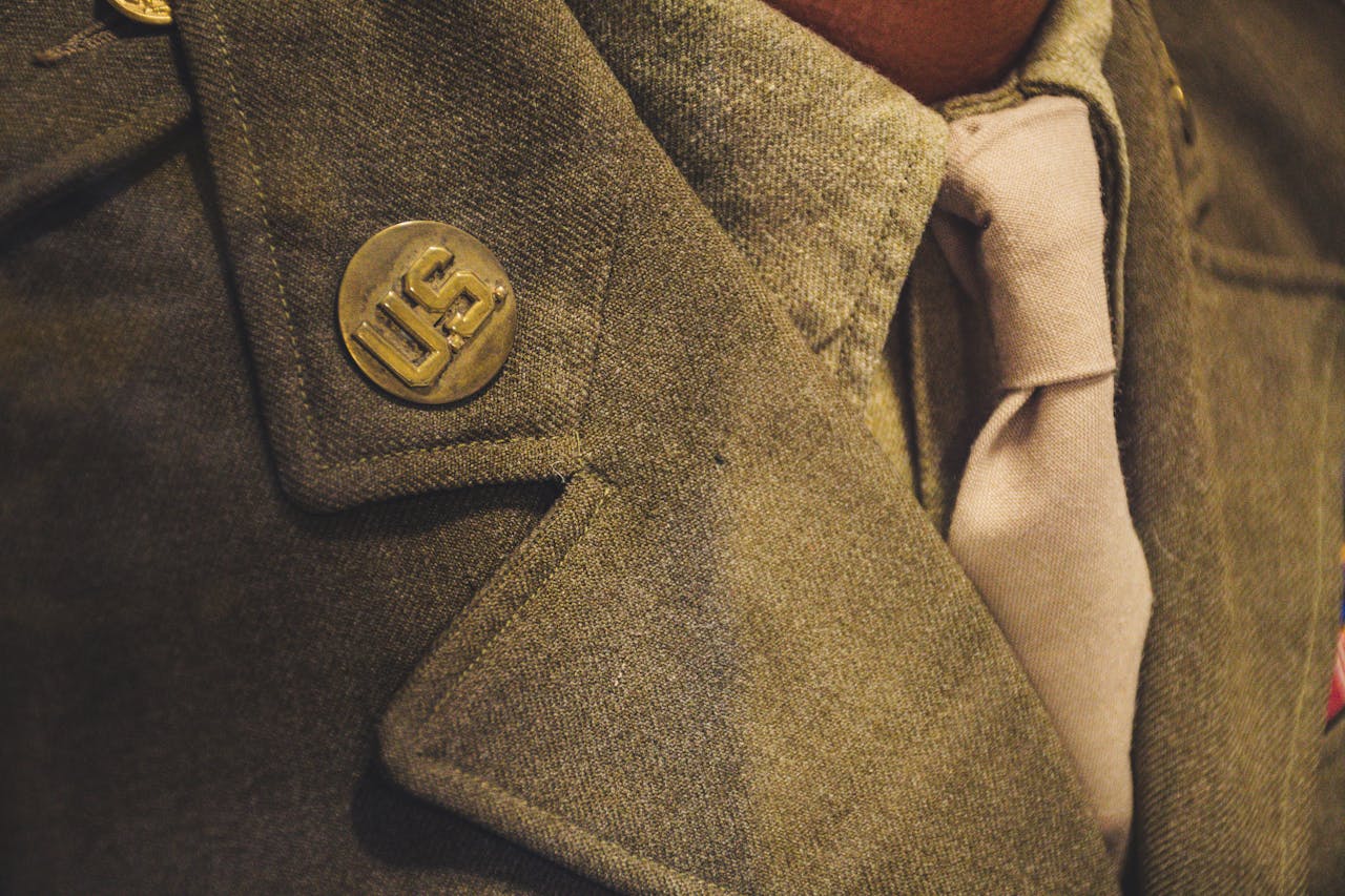 Detailed shot of a US military jacket showcasing button and tie.